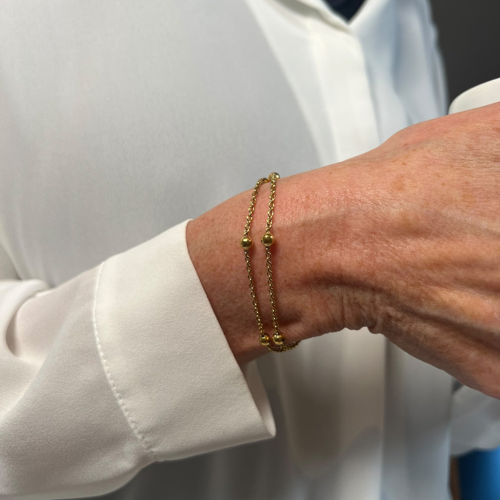 Dobbelt kæde-armbånd med små gulddetaljer